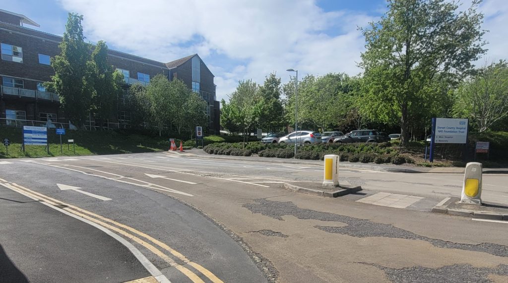 Main site entrance from Williams avenue showing road, island and signage