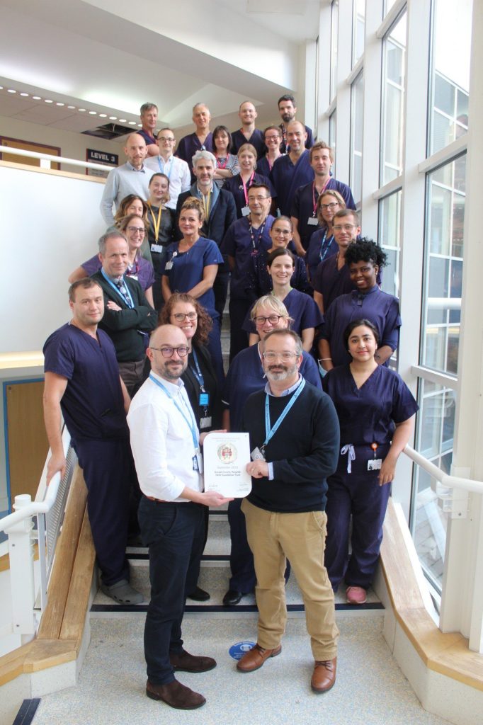 Anaesthetics and theatre teams gather to receive their accreditation plaque