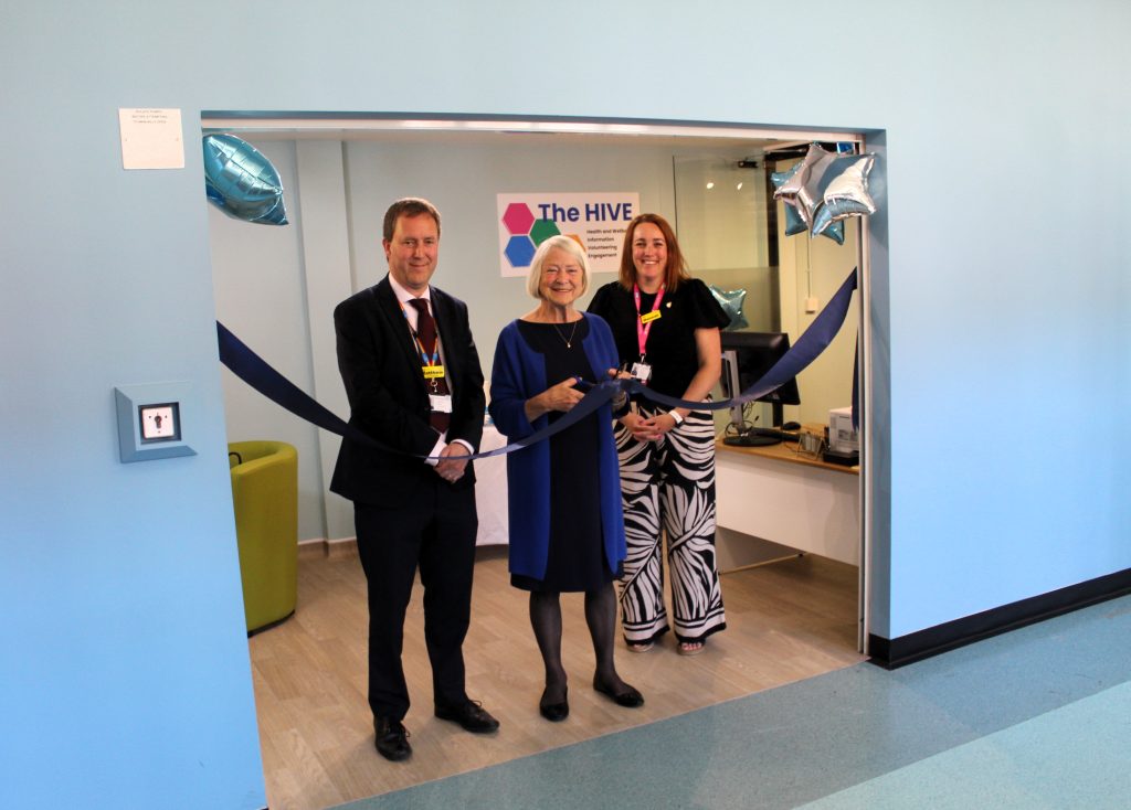 The HIVE opening3 Three individuals participate in a ribbon-cutting ceremony at